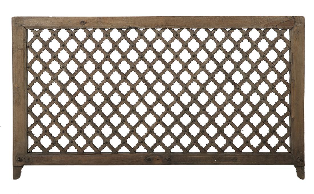 Indian Teakwood Architectural Window Panel: Indian Teakwood Architectural Window Panel ca. 1900, the rectilinear frame surrounding carved scrollwork, the joints adorned with carved rosettes, the bottom back section with loose molding. h. 35", w