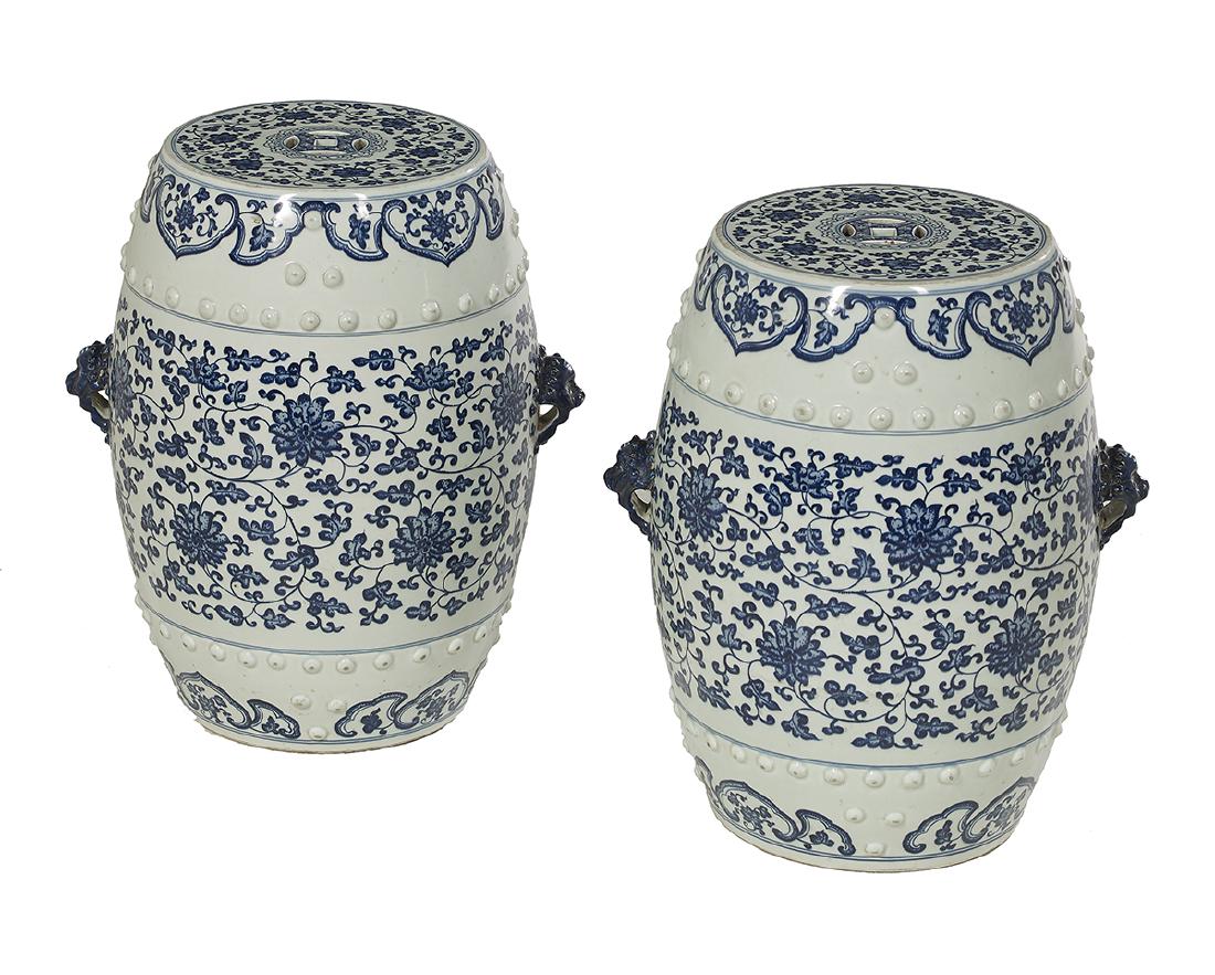 Pair of Chinese Blue and White Garden Stools: Pair of Chinese Blue and White Porcelain Garden Stools 20th century, each with pierced "cash" symbol to the top, and mounted with lion-head handles to the sides, decorated with a scrolling peony desig