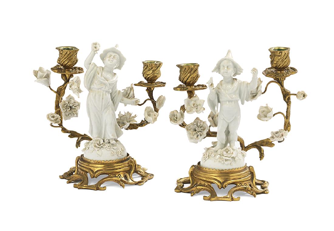 Pair of Gilt-Bronze and Blanc-de-Chine Candelabra: Pair of Gilt-Bronze and Blanc-de-Chine Candelabra second quarter 20th century, French, the two-light candelabra in the rococo taste, with pierced bronze stands set with porcelain chinoiserie figures a