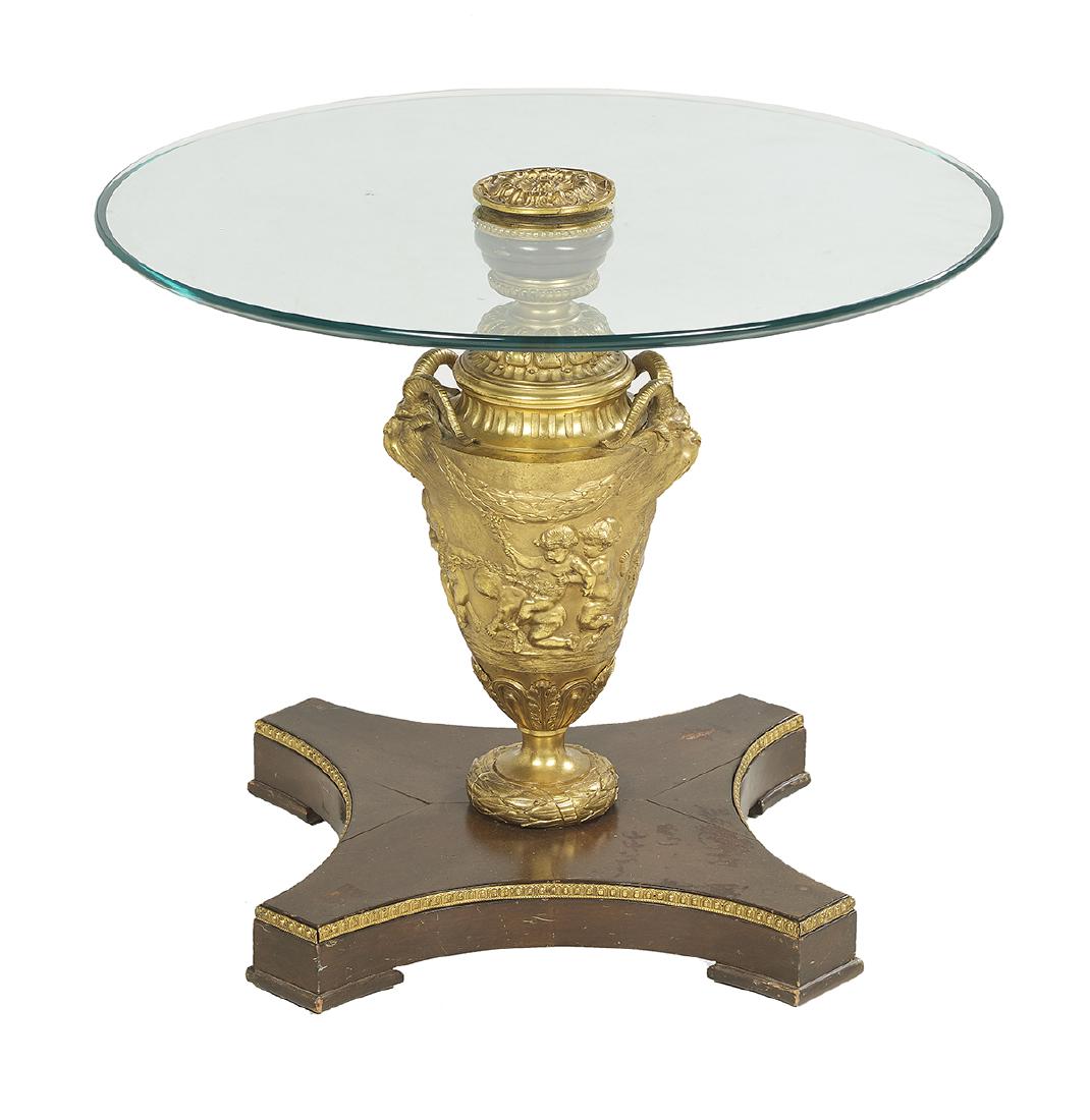 French Glass-Top Occasional Table: French Gilt-Bronze, Mahogany and Glass-Top Occasional Table mid-20th century, the mahogany platform base supporting a gilt-bronze urn-form pedestal molded with putti and ram's-head handles, and fitted