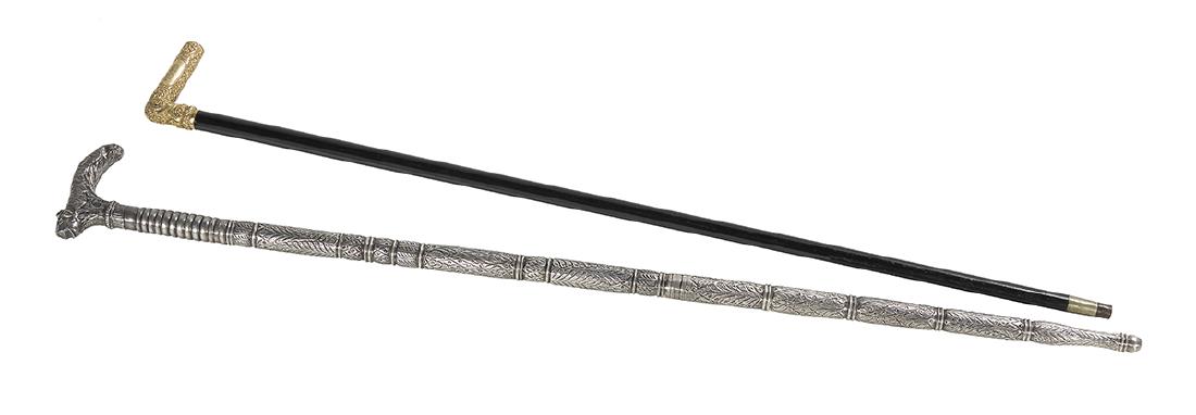 Two 19th-Century Canes: Two 19th-Century Canes including a silver-clad cane with elaborate decoration, l. 36-3/4", and an ebony walking stick with gold-filled rococo-scroll crop handle, monogrammed "TMS", l. 35-5/8.