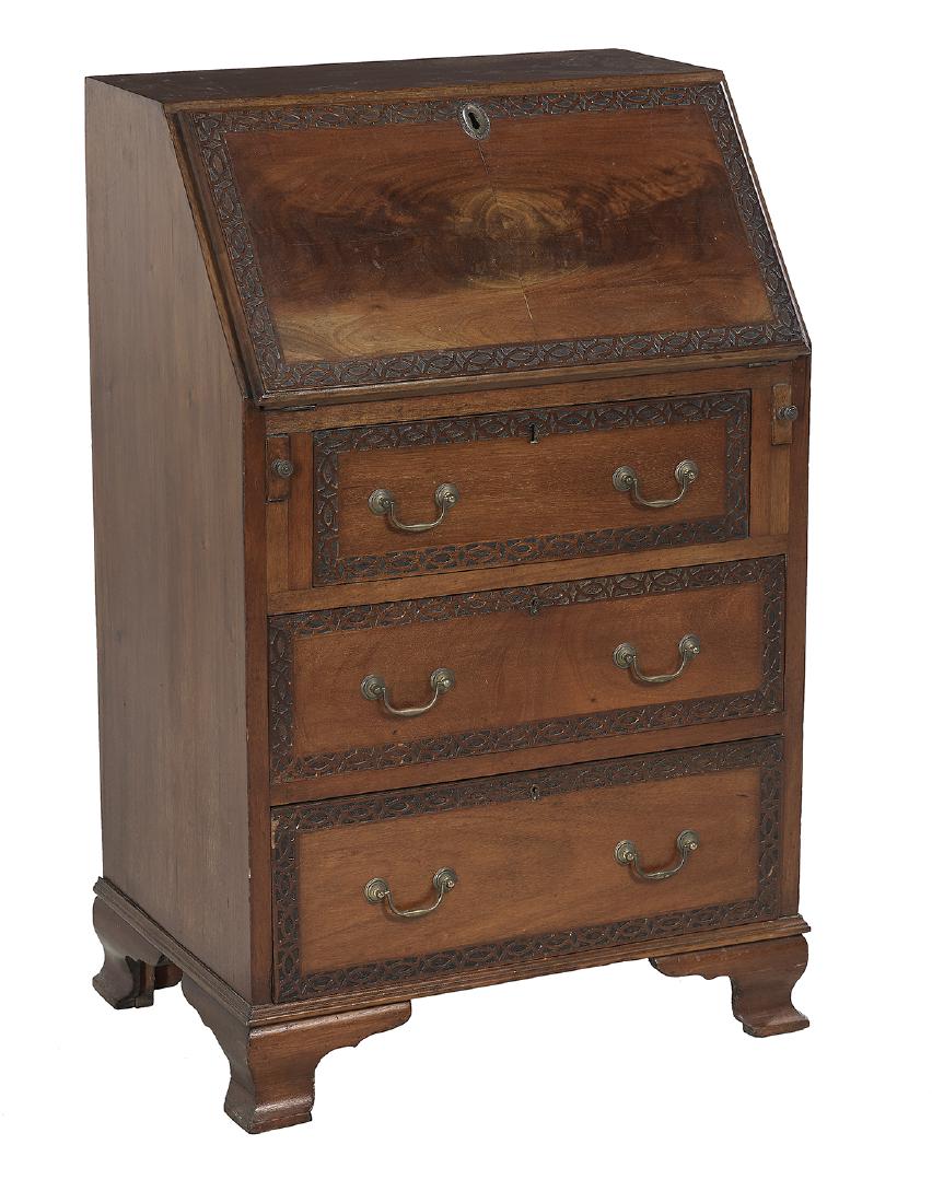 George III-Style Mahogany Slant-Front Desk: Diminutive George III-Style Mahogany Slant-Front Desk ca. 1900, in the Chippendale taste, the figured slant lid and drawers with blind fretwork-carved borders, on bracket feet. h. 38", w. 25", d. 17-1