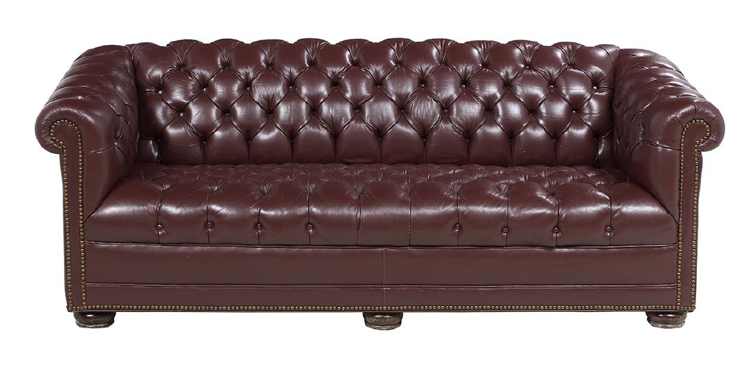 Edwardian-Style Leather Chesterfield Sofa: Edwardian-Style Leather Chesterfield Sofa of traditional form with tufted back, seat and arms, on bun feet, upholstered in oxblood leather. h. 27-3/4", w. 74", d. 33"