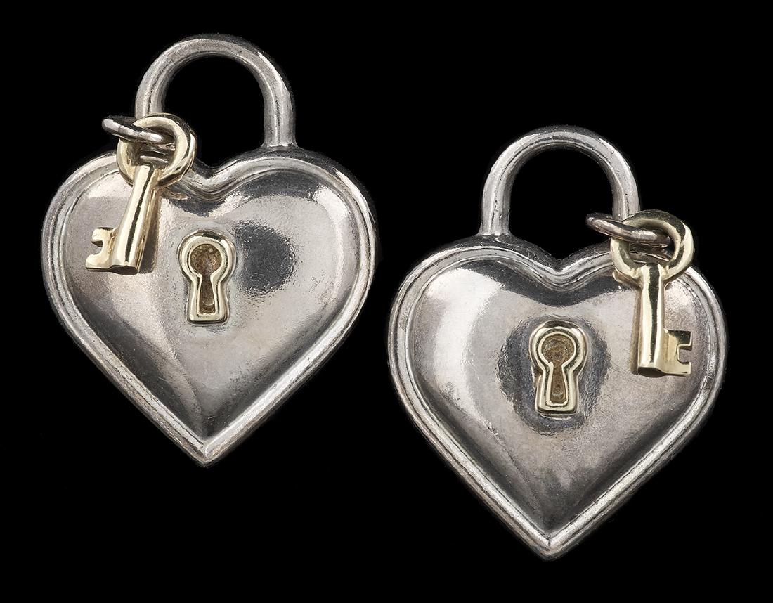 Pair of Tiffany & Company Ear Clips: Pair of Tiffany & Company Ear Clips 18k yellow gold/sterling silver, the hear-shaped pad lock ear clips with keys and stamped "Tiffany & Co. 925 750, 1994", together with a Tiffany & Co. blue pouch. l