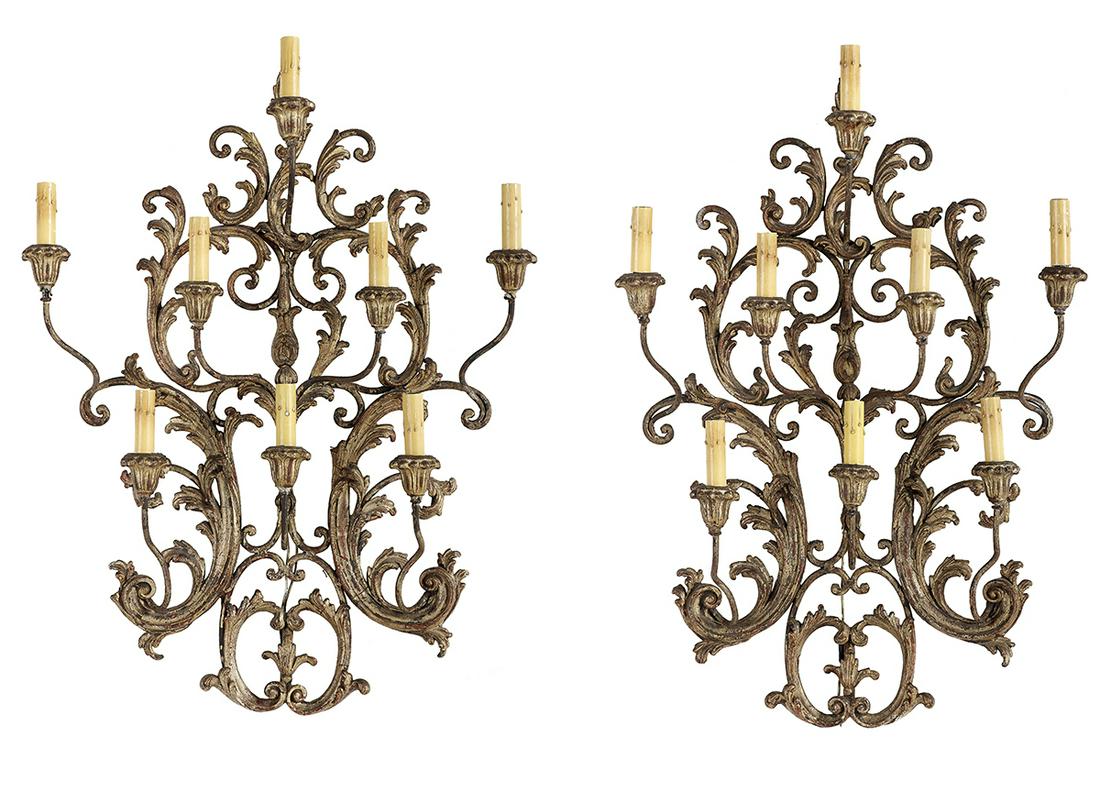 Pair of Italian Carved Giltwood Sconces: Pair of Italian Carved Giltwood Sconces 20th century, the eight-light sconces composed of delicately carved and pierced scrollwork, and set with gilt-metal candle arms with lotus-carved wooden candle 