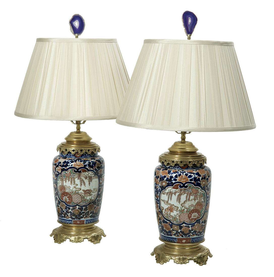 Pair of Japanese Imari Vases/Lamps: Pair of Japanese Imari Porcelain Vases Mounted as Table Lamps 20th century, with ormolu mounts, fitted with shades with amethyst finials. h. 25-1/2", dia. 15-3/4" Provenance: Bruce McCashin Collection