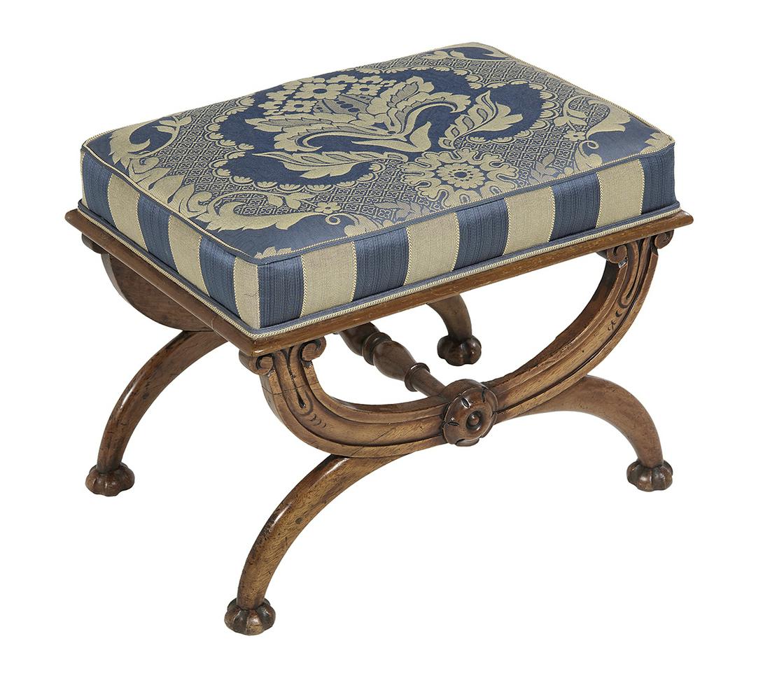 William IV Fruitwood Footstool: William IV Fruitwood Footstool second quarter 19th century, the padded rectangular top raised on a crossover curule-form base ending in fluted bun feet, with scroll and patera carving. h. 16", w. 21-1