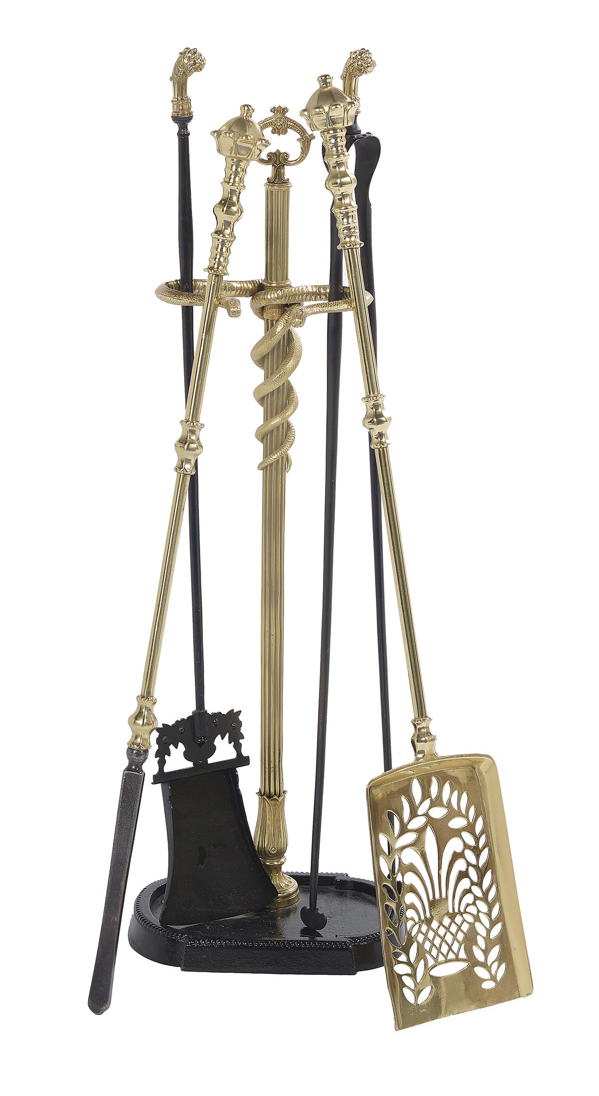 Victorian Fire Tool Holder and Tools: Victorian Brass, Iron and Steel Fire Tool Holder and Tools fourth quarter 19th century, the tool holder with serpent-molded arms and an iron base, with steel tongs and shovel with brass leopard-head h
