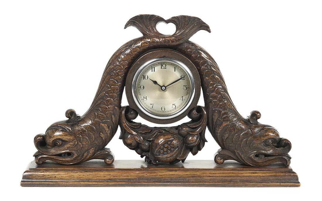 Gillows, London, Carved Oak Mantel Clock: Gillows, London, Carved Oak Mantel Clock second quarter 20th century, English, the case carved with a pair of entwined classical dolphins and swags of fruit. h. 10-1/2", w. 17-1/4", d. 3" Provenance: 