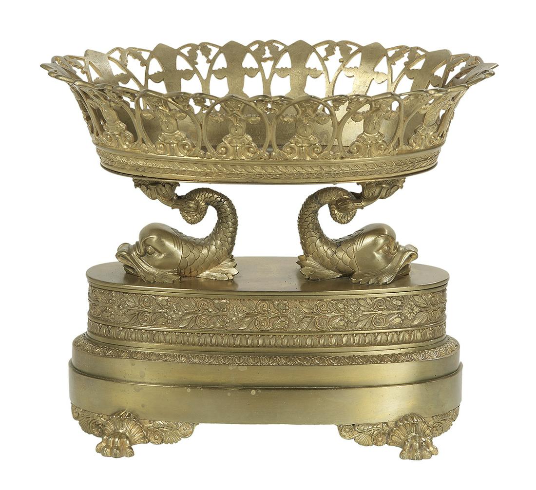 French Empire Bronze Corbeille: French Empire Bronze Corbeille first quarter 19th century, on an oval base decorated with flowers and laurel leaves, raised on paw feet, a pair of molded dolphins supporting the flared pierced basket,