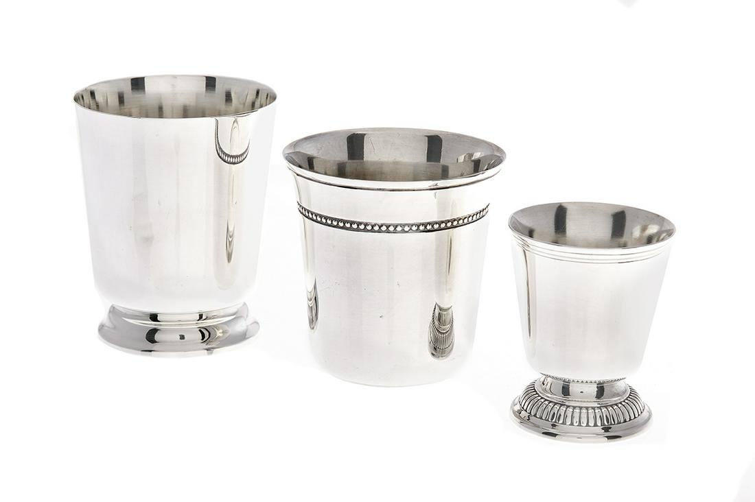Three Christofle Sterling Silver Beakers: Three Christofle Sterling Silver Beakers contemporary, Paris, including: a footed example, 1983-1992, with molded foot, h. 3", dia. 2-1/2"; a small footed example, 1983-1992, with gadrooned foot, h. 2