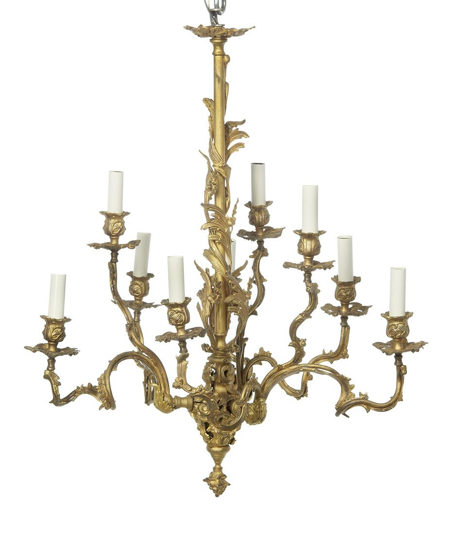 French Gilt-Bronze Chandelier: French Gilt-Bronze Chandelier first quarter 20th century, in the Louis XV taste, the standard wrapped with leaves and flowerheads, the rocaille arms set with floriform drip pans and candle cups with l