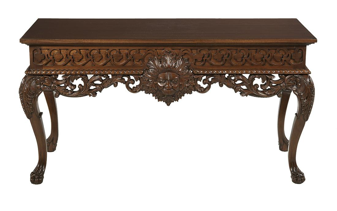 Console Table in the Manner of William Kent: Carved Mahogany Console Table in the Manner of William Kent 20th century, the rectangular overhanging top above a blind fretwork frieze centered with a carved lion's masque, and raised on cabriole leg