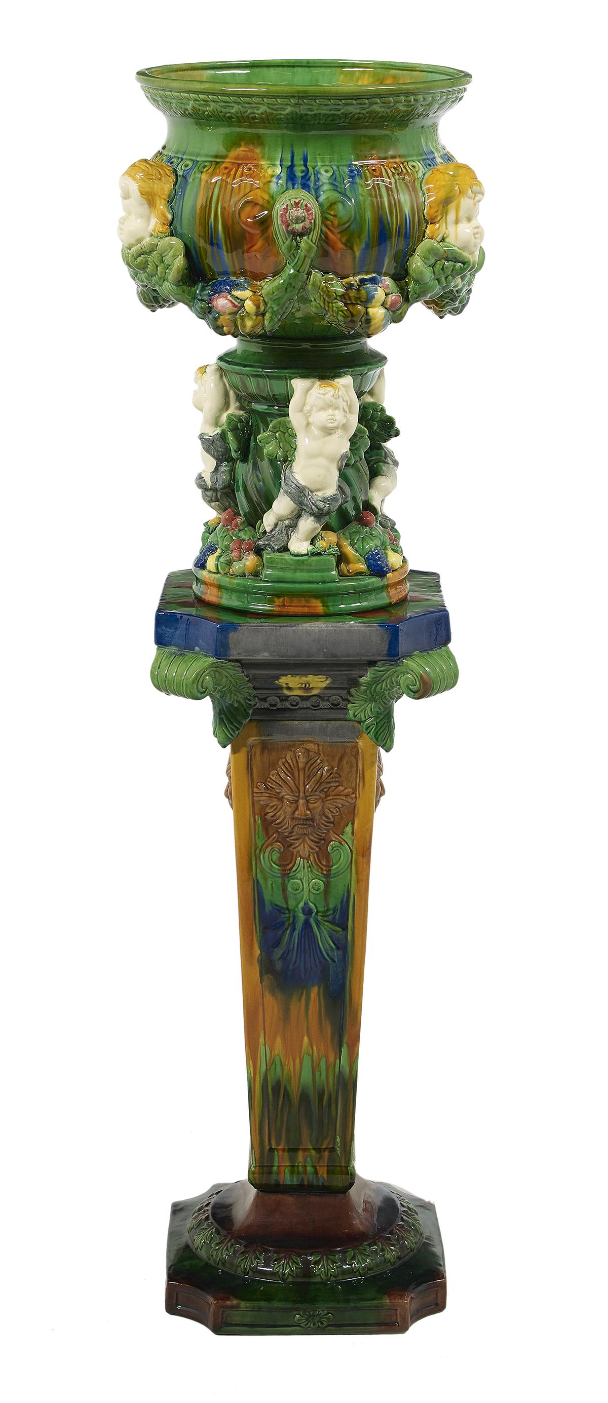 Victorian-Style Majolica Jardiniere on Stand: Victorian-Style Majolica Jardiniere on Stand 20th century, with a mottled green, cobalt and brown glaze, and molded with putti. h. 51-1/2", dia. 13-1/2" Provenance: The Estate of Donald J. Hurst, Wate