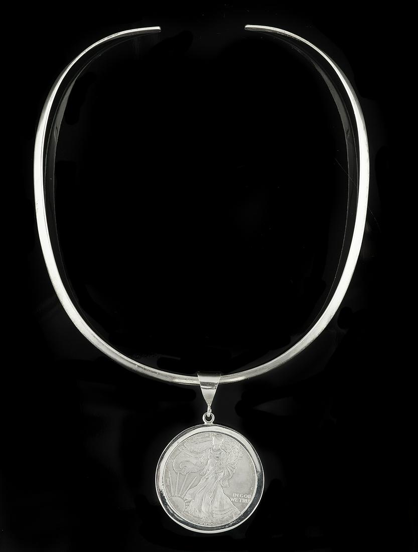 Silver Eagle Pendant on Choker: Silver Eagle Pendant on Choker sterling silver, the pendant mounted with a one ounce 0.999 fine silver $1.00 United States Silver Eagle coin, suspended from a solid silver choker. l. 16-3/4", total we