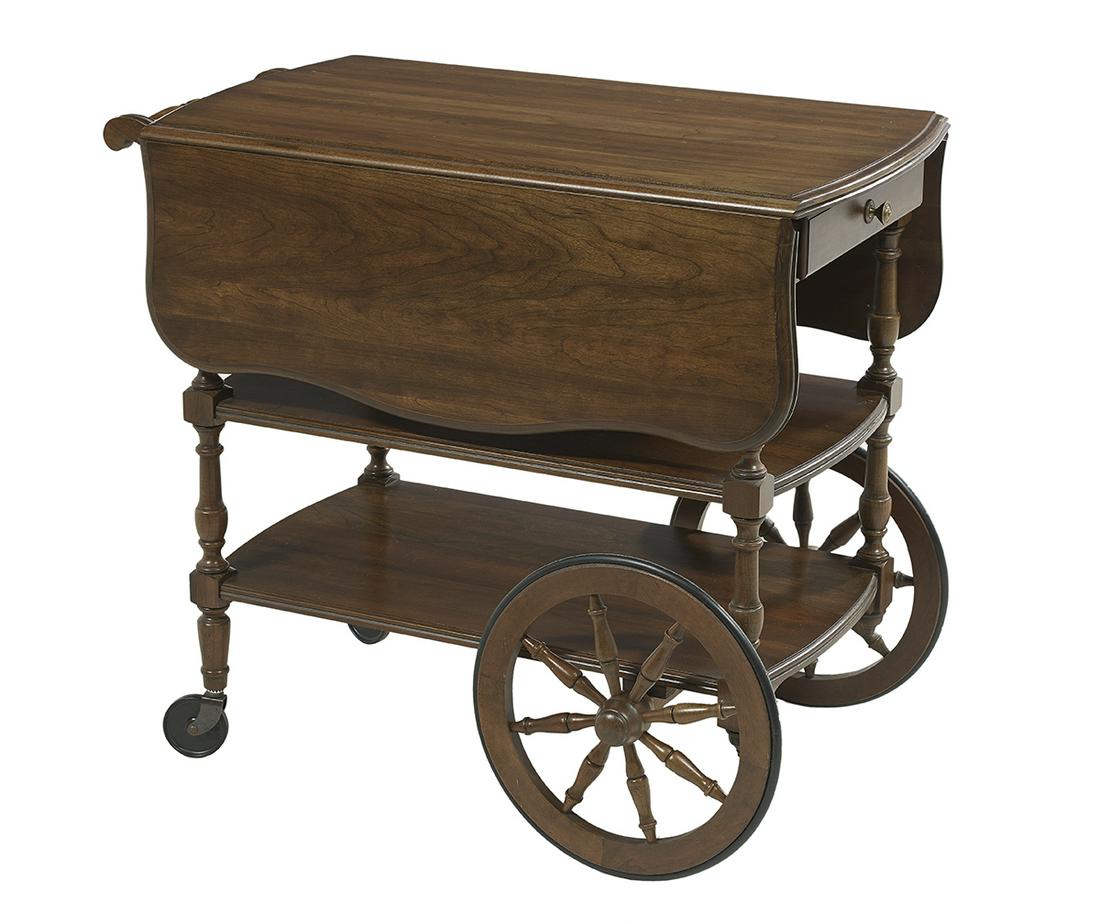 Colonial Revival Walnut-Stained Trolley: Colonial Revival Walnut-Stained Trolley the top with serpentine drop leaves, the tea cart's frieze fitted with a folding handle on one end and a drawer on the other, raised on turned columns supportin