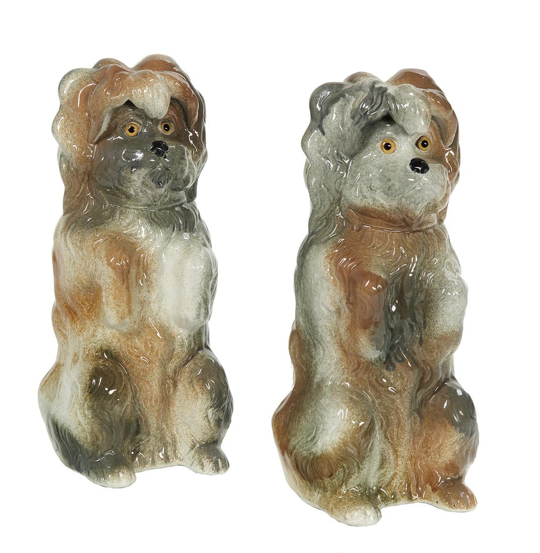 Pair of Victorian Staffordshire Pottery Terriers: Pair of Victorian Staffordshire Pottery Terriers fourth quarter 19th century, set with glass eyes, the mottled brown and gray dogs poised on their hind legs. h. 14-1/4", w. 5-1/2", d. 8" Provenance: B