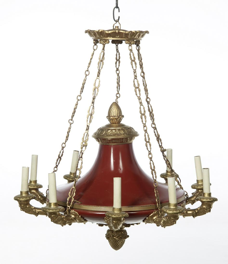 French Empire-Style Gilt-Bronze Chandelier: French Empire-Style Red Tole and Gilt-Bronze Chandelier first quarter 20th century, the red tole body set with bronze candle arms molded with satyr masques, and a leaf-molded cone-form pendant finial,