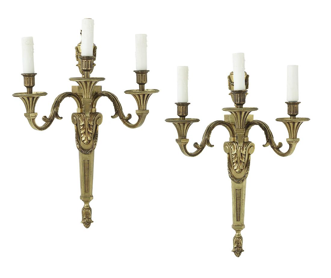 Pair of Louis XVI-Style Bronze Sconces: Pair of Louis XVI-Style Bronze Sconces second quarter 20th century, the tapered backplates molded with acanthus leaves and laurel swags, and set with flame finials on urns hung with swags, the scrolle