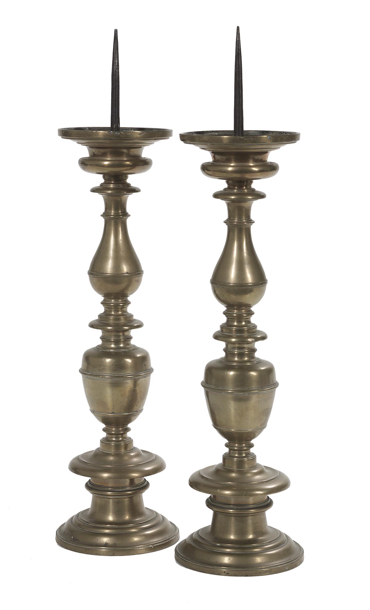 Pair of Continental Baroque Bronze Pricket Sticks: Pair of Continental Baroque Bronze Pricket Sticks mid-17th century, with vasiform, cup and ring turnings, incised on the underside "P. Lorenzo Martini Priora di Ronta 1663" flanking a coat of arms wit