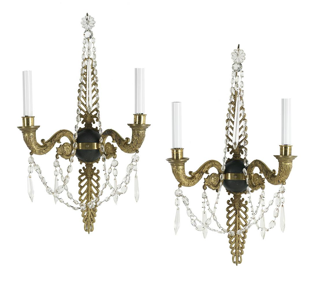 Pair of Empire-Style Bronze and Crystal Sconces: Pair of French Empire-Style Bronze and Crystal Sconces second quarter 20th century, each with a backplate decorated with pierced anthemia and fitted with a pair of scrolled candle arms decorated with 