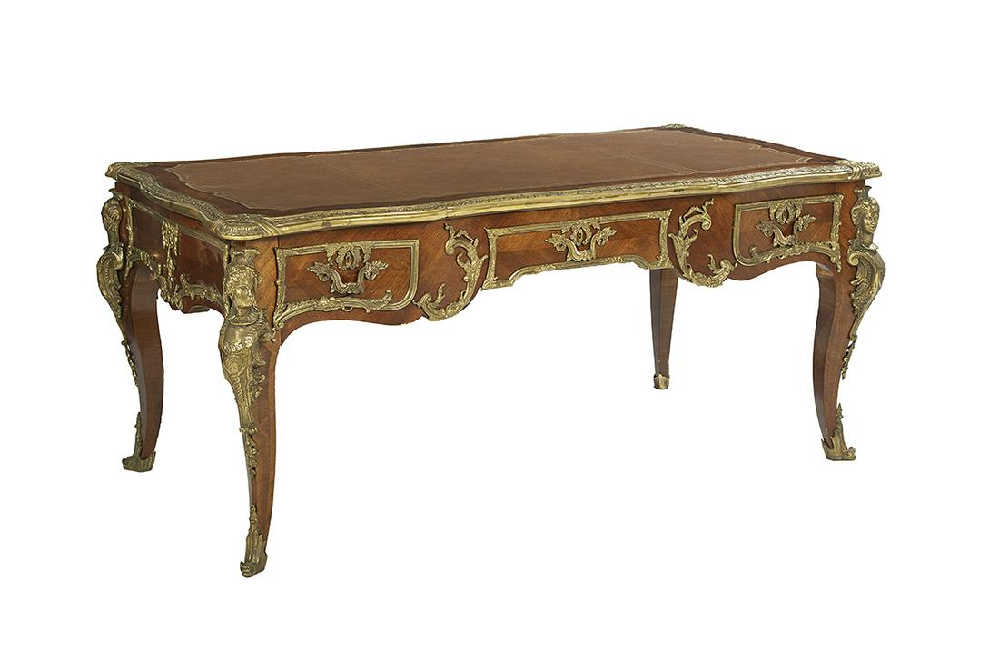 Louis XV-Style Ormolu-Mounted Bureau Plat: Louis XV-Style Ormolu-Mounted Kingwood Bureau Plat 20th century, the shaped rectangular top with an inset tooled leather writing surface and molded brass edging, above a conforming frieze fitted with 