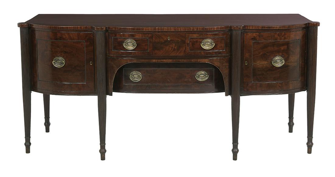 George III Mahogany Sideboard: George III Mahogany Sideboard ca. 1800, in the Sheraton taste, probably Irish, the top with a bow-fronted center section and banded edge, above a curved drawer and recessed drawer below, flanked by a 