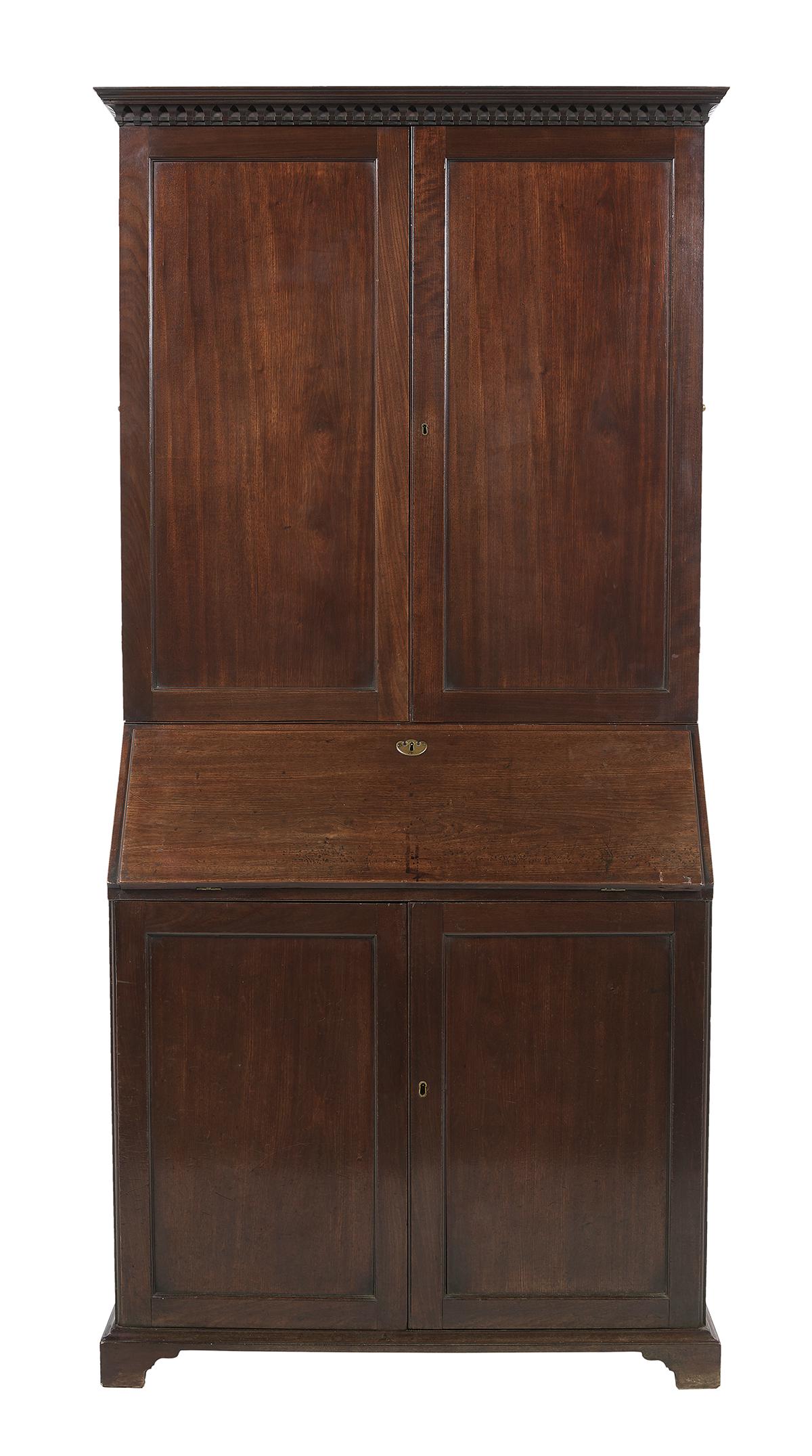 George III Mahogany Secretary with Bookcase: George III Mahogany Secretary with Bookcase 18th century, with a dentillated overhanging cornice, the upper case with a pair of framed and paneled blind doors, the base with a slant lid opening to a f
