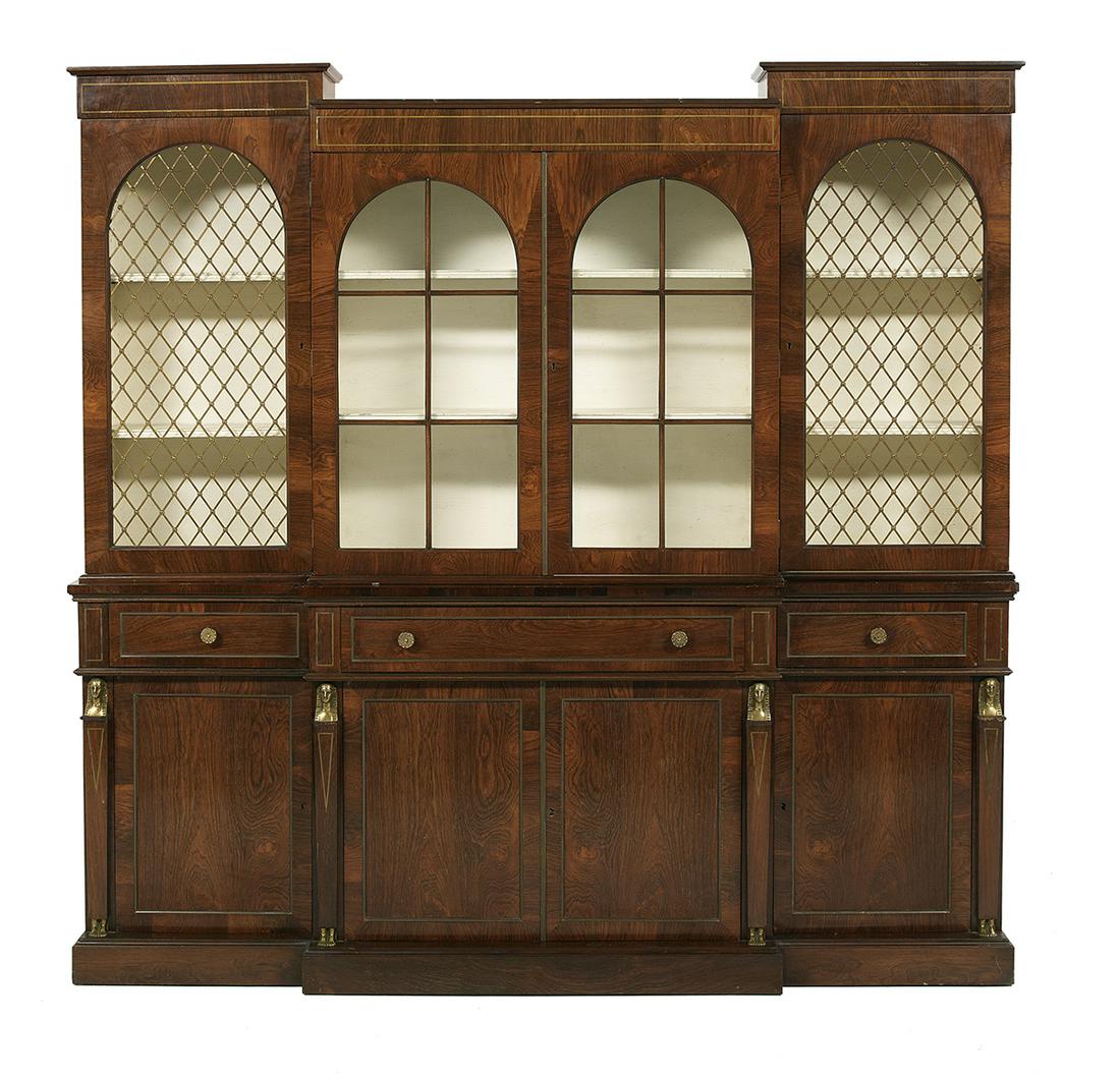 Regency-Style Rosewood and Mahogany Breakfront: Regency-Style Rosewood and Mahogany Breakfront 19th century, the molded cornice above a lower center section fitted with two glazed doors, flanked to either side by an arched grilled door, the lower s