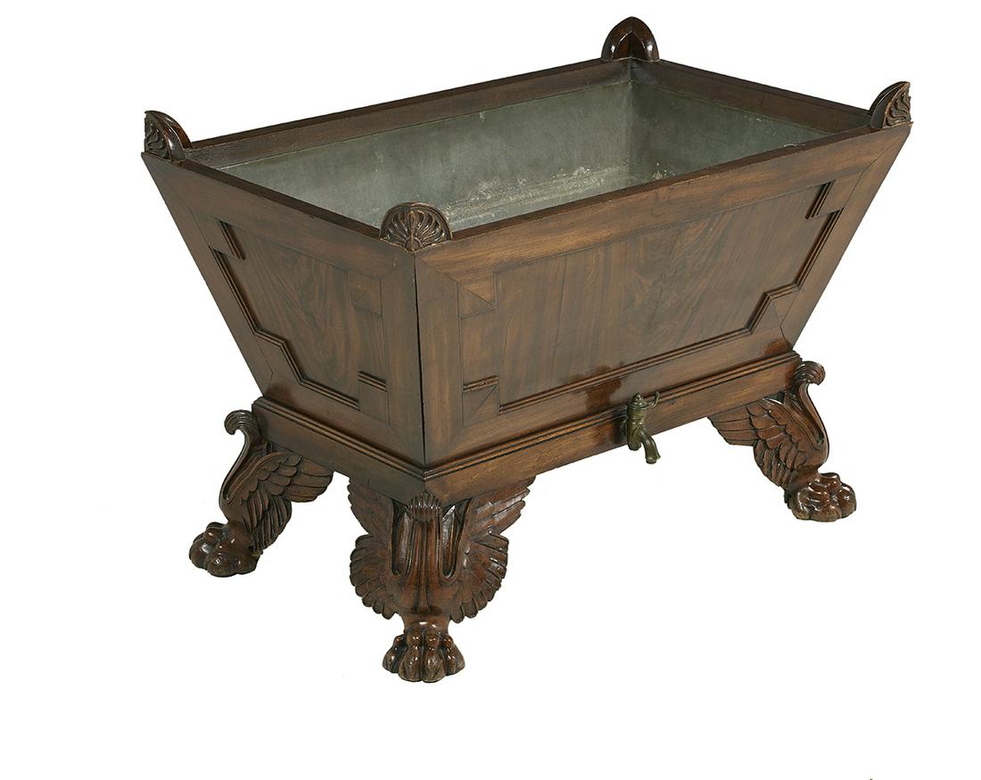 William IV Mahogany Jardiniere/Cellarette: William IV Mahogany Jardiniere/Cellarette second quarter 19th century, of sarcophagus form, each corner mounted with an anthemion carving, the case with figured panels, the interior with a tole liner,