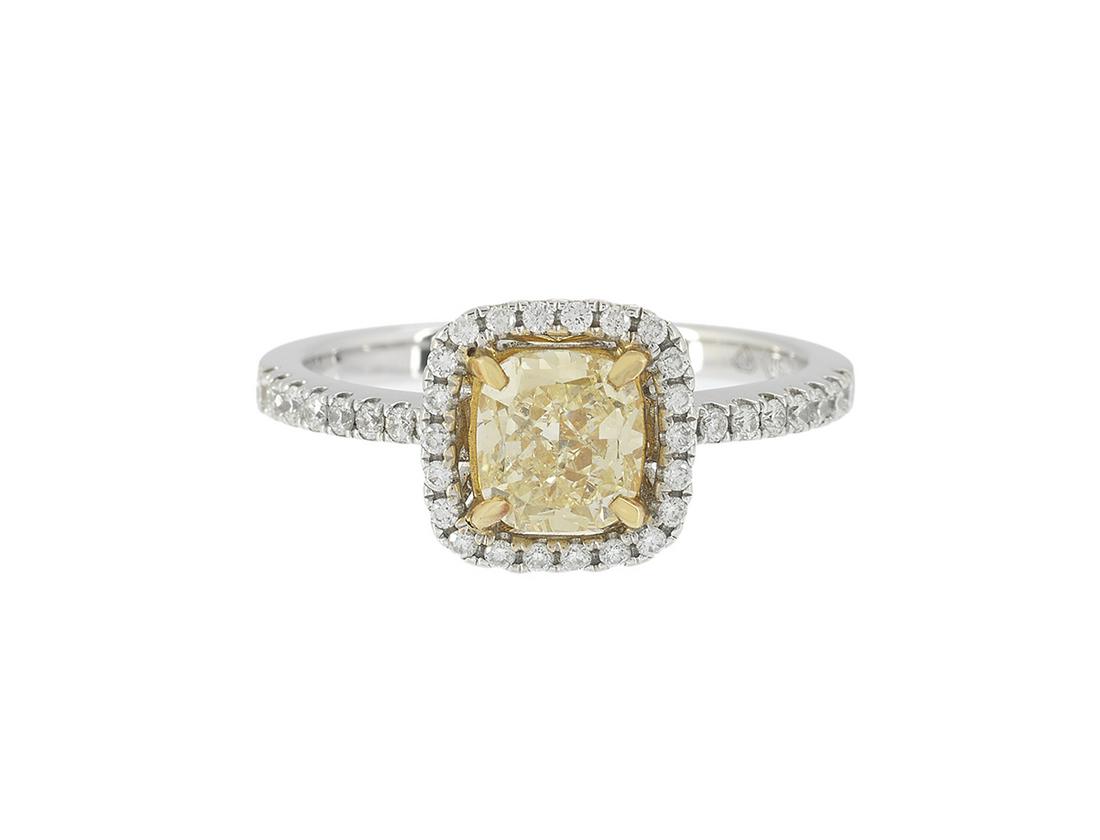 Fancy Light Yellow Diamond Ring: Fancy Light Yellow Diamond Ring 18k white gold, the ring mounted with a cushion-cut Fancy Light Yellow diamond weighing 1.04 carats, clarity VS1, GIA report #5151317397, accented by round brilliant-cu