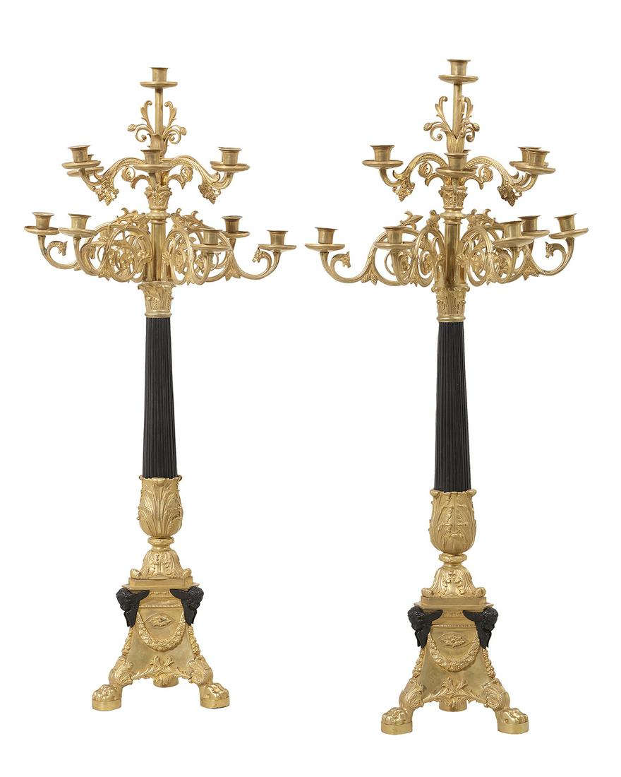 Pair of French Gilt & Patinated Bronze Candelabra: Pair of French Gilt- and Patinated Bronze Candelabra 20th century, in the Empire taste, each with a tapered and reeded standard set with scrolled candle branches, decorated with griffin's heads and fl