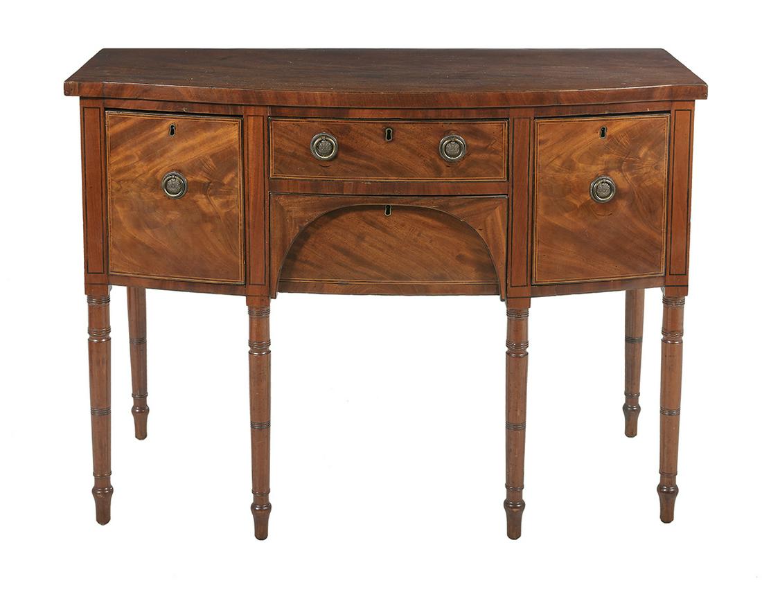 George III Mahogany Sideboard: George III Mahogany Sideboard early 19th century, the bowed top above a conforming case fitted with a central drawer over a recessed well drawer, flanked to either side by a deep drawer, all within ba