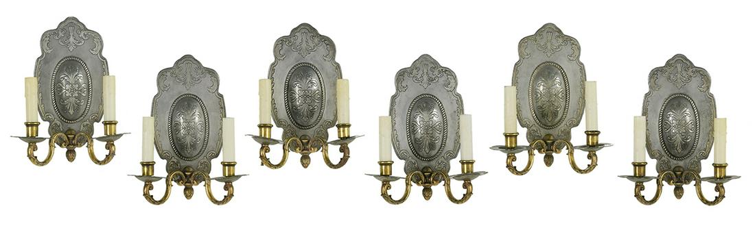 Set of Six Steel and Bronze Sconces: Set of Six Steel and Bronze Sconces in the Baronial Taste second quarter 20th century, the steel backplates decorated with scrollwork and roping, and fitted with leaf-molded bronze arms set with bronz
