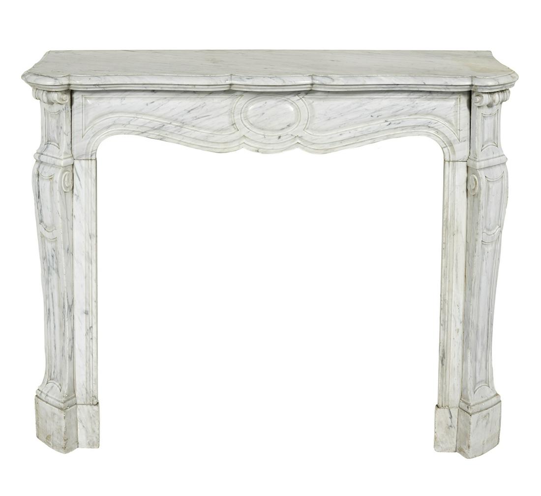 French Marble Fireplace Surround: French Marble Fireplace Surround 19th century, in the Louis XV taste, the shaped deck with a molded edge, above an in-carved scalloped and paneled frieze, the side supports with scrolled brackets and 