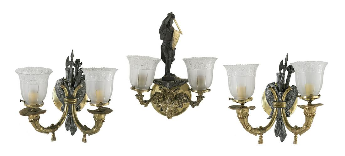 Three Victorian Metal and Glass Gas Sconces: Three Victorian Brass, Metal and Glass Gas Sconces mid-19th century, English, including a pair of sconces decorated with metal shields and battle axes, set with leaf-molded arms and later glass shades