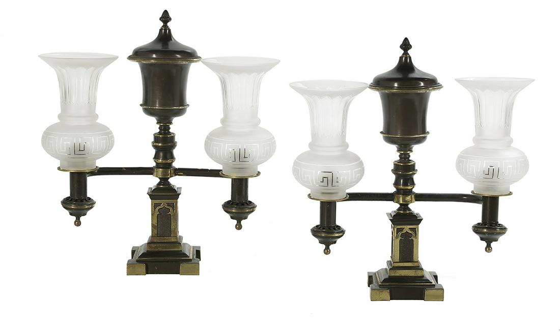 Pair of William IV Gothic Revival Argand Lamps: Pair of William IV Bronze Gothic Revival Argand Lamps second quarter 19th century, each with a patinated and gilt-bronze finish, set with an urn-form fuel tank, the rectangular base molded with Gothic