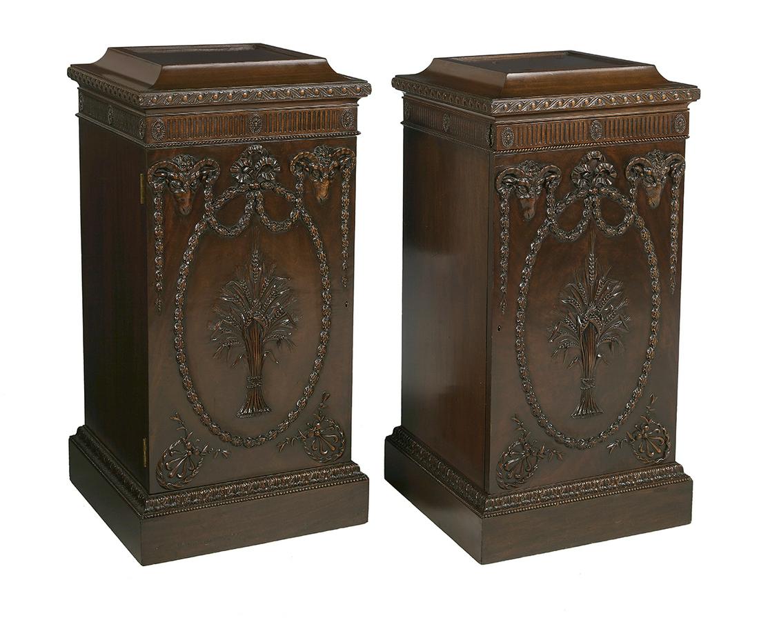 Pair of Edwardian Mahogany Pedestal Cabinets: Pair of Edwardian Mahogany Pedestal Cabinets ca. 1900, in the Adam taste, each with a stepped square top above a case fitted with a fluted frieze over a single cupboard door, with corner carved ram's 