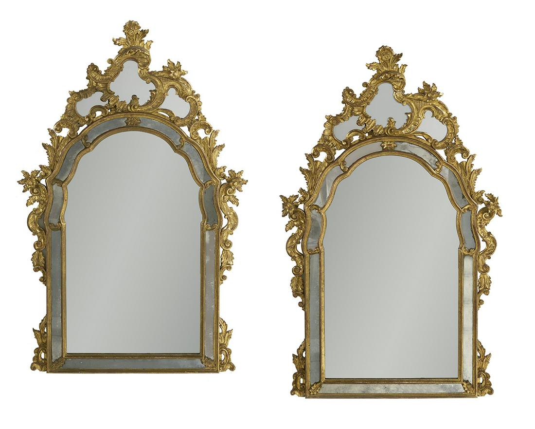 Pair of Italian Rococo-Style Giltwood Mirrors: Pair of Italian Rococo-Style Giltwood Mirrors early 20th century, each of arched form, the outer mirror plate with C-scroll and floral accents, surmounted by a tripartite rocaille- and floral-carved c