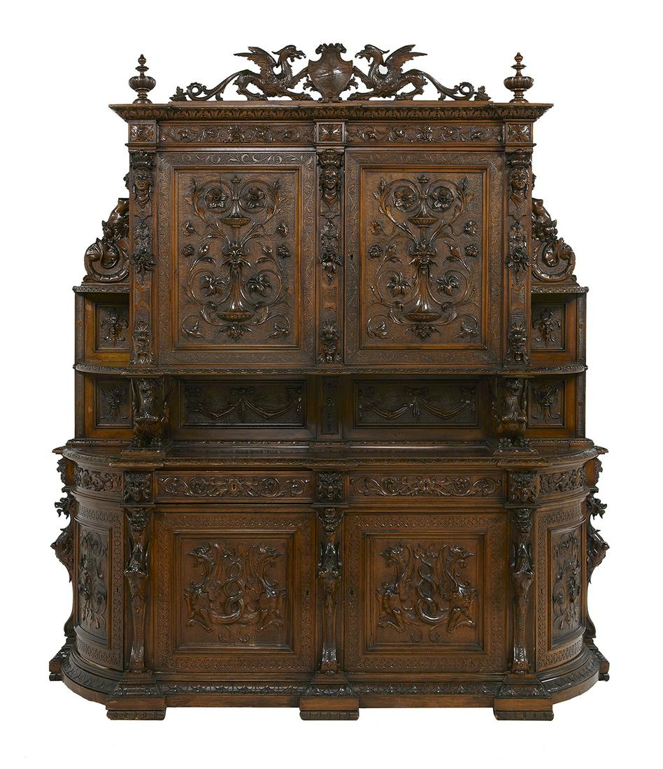 Impressive Continental Carved Walnut Cabinet: Impressive Continental Carved Walnut Cabinet fourth quarter 19th century, in the Renaissance taste, profusely carved with an elaborate crest with a pair of winged griffins centered by a carved shield,