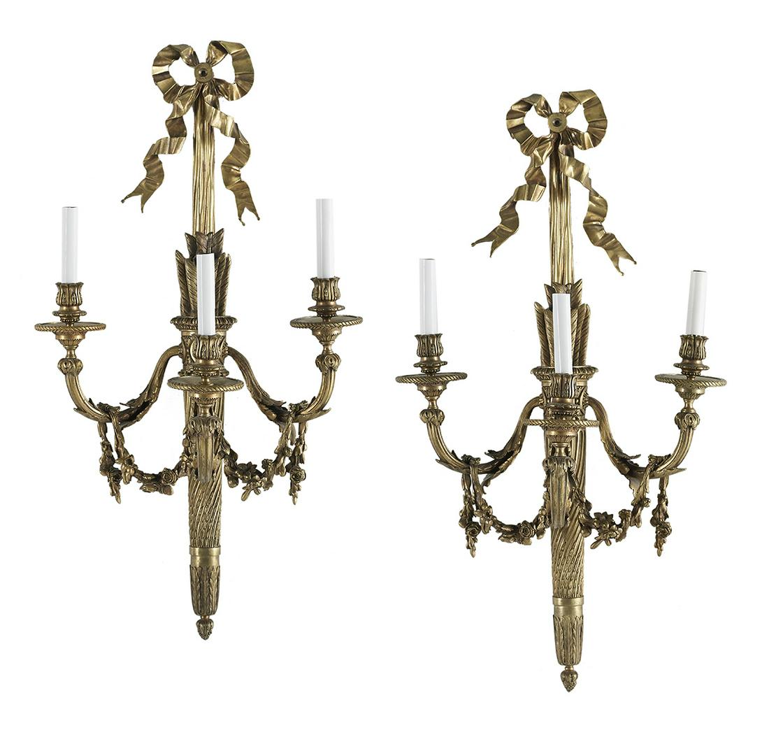 Pair of Large French Gilt-Bronze Sconces: Pair of Large French Gilt-Bronze Sconces mid-20th century, in the Louis XVI taste, the quiver-and-arrow-form standards supported by bowknots, the leaf-molded arms hung with swags of roses and set with