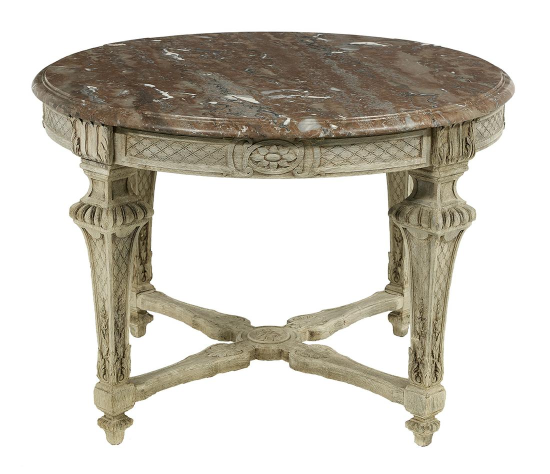 Louis XVI-Style Marble-Top Center Table: Louis XVI-Style Polychrome and Marble-Top Center Table the circular marble top with a molded edge, above a conforming paneled frame with lattice-patterned incising and carved patera accents, raised on