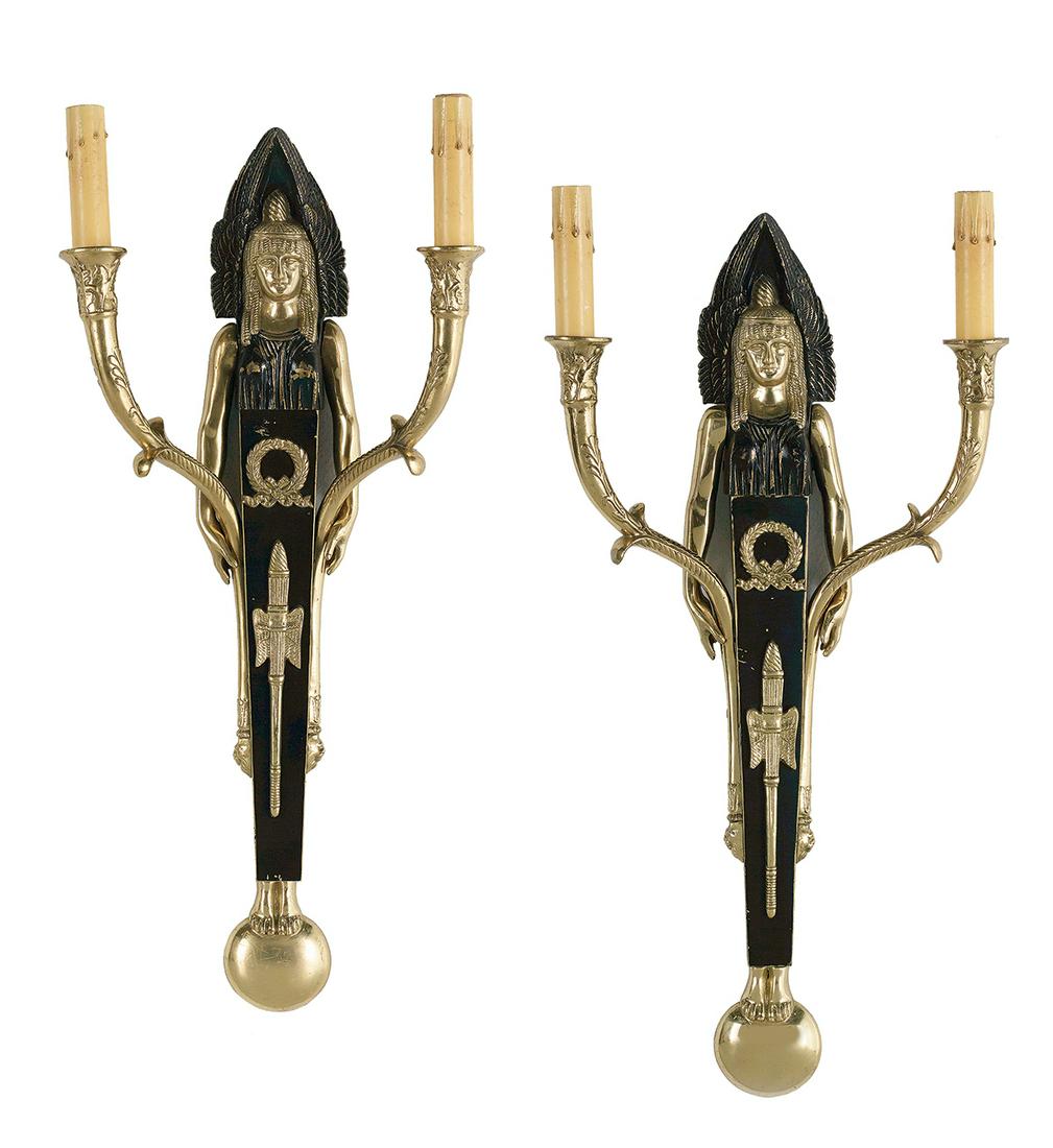 Pair of Egypto-Revival-Style Bronze Sconces: Pair of Egyptian-Revival-Style Gilt and Patinated Bronze Sconces third quarter 20th century, each having a mummiform backplate decorated with wings and wreaths, and fitted with a pair of quiver-form c