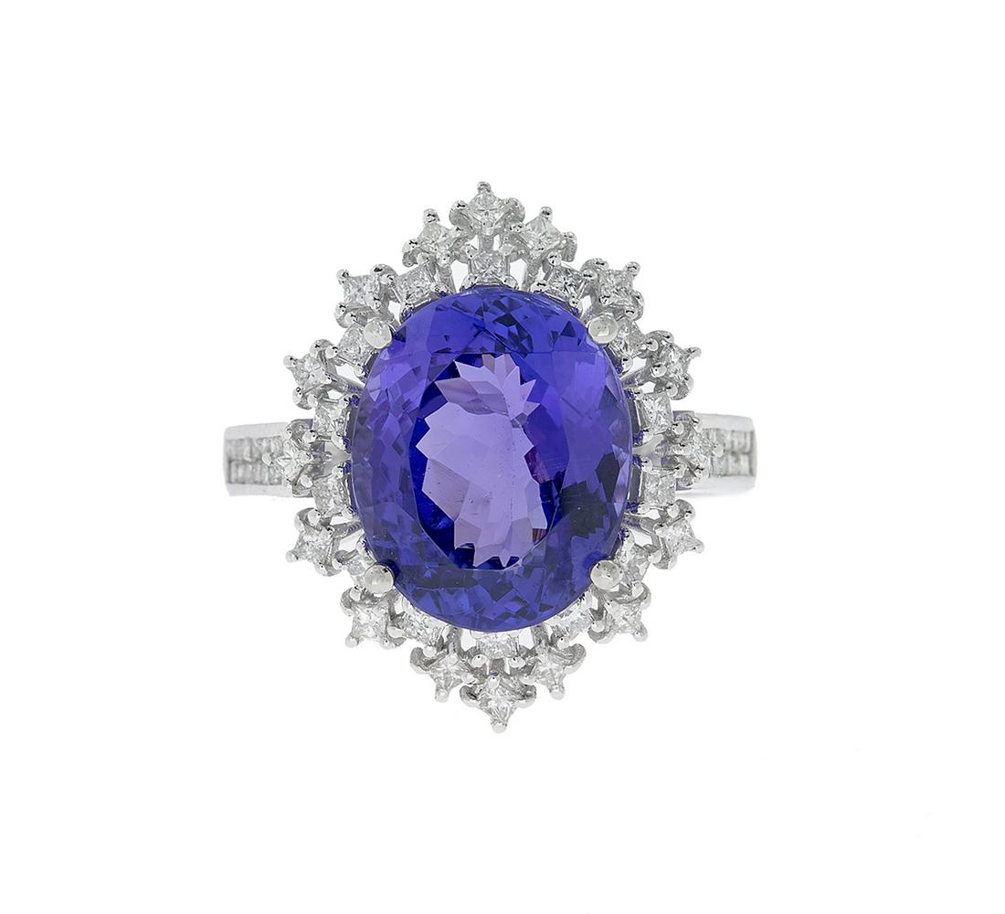 Tanzanite and Diamond Ring: Tanzanite and Diamond Ring 14k white gold, the ring mounted with an oval-cut tanzanite weighing approximately 6.96 carats, accented by round brilliant-cut diamonds weighing approximately 0.78 carats i