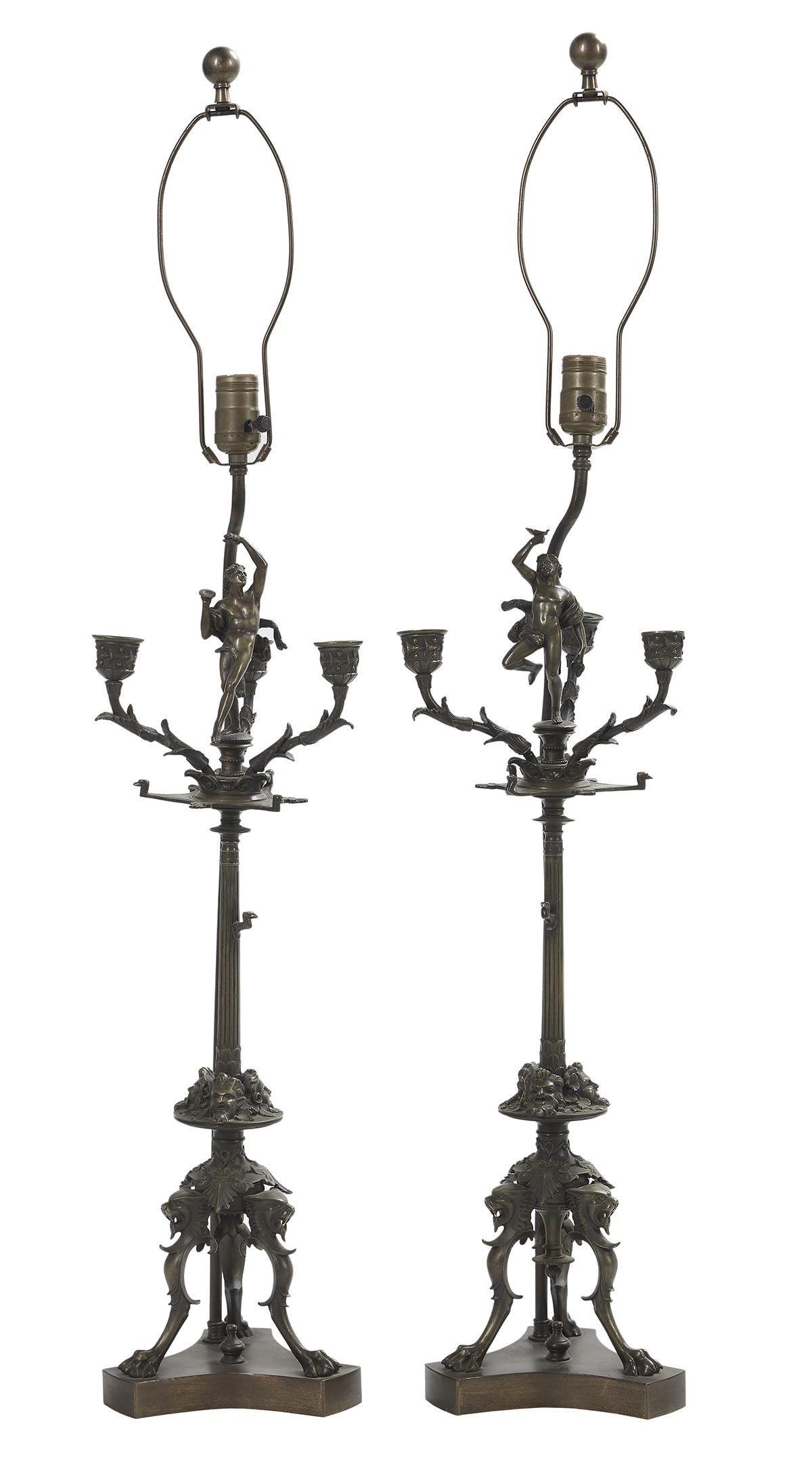 Pair of Italian Aesthetic Bronze Candelabra: Pair of Italian Aesthetic Bronze Candelabra third quarter 19th century, now mounted as lamps, on paw feet terminating in lion's heads, the standards decorated with anthemia and classical heads, mounte