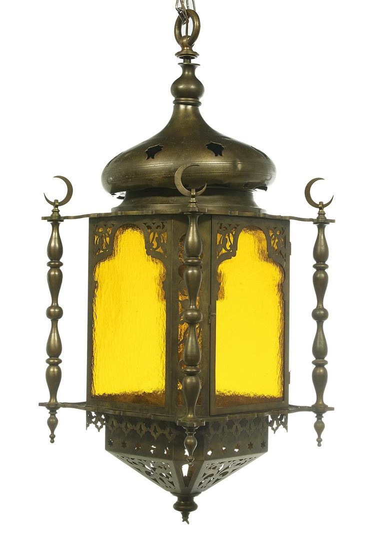 Moorish-Style Bronze, Brass and Glass Lantern: Moorish-Style Bronze, Brass and Glass Lantern second quarter 20th century, with turned bronze side standards set with half-moon finials, the pierced brass frame with Moorish arched sides set with text