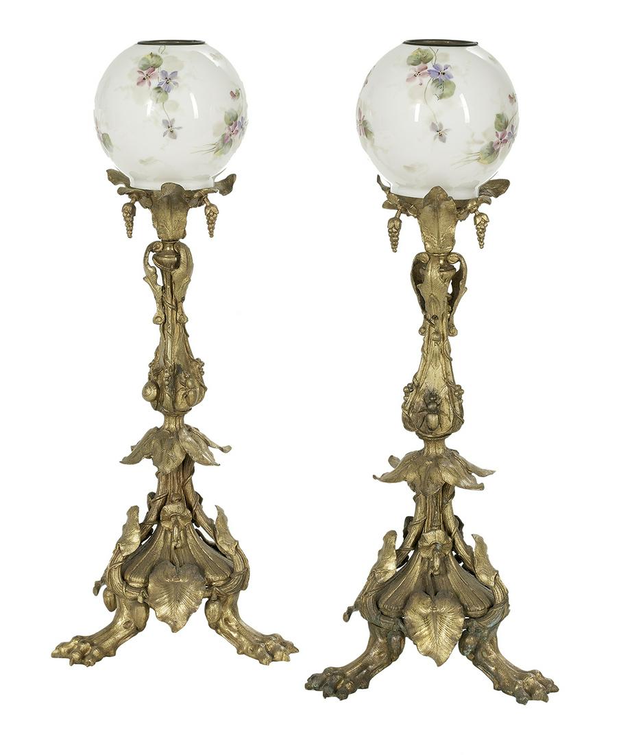 Pair of English Rococo Revival Lamp Standards: Pair of English Rococo Revival Lamp Standards now mounted as lamps, molded with anthuriums, insects and shells, on paw feet, with later but antique ball shades, electrified. h. 20", dia. 7-1/2"