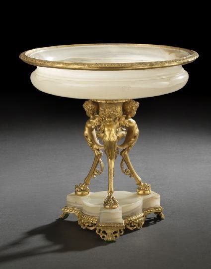 French Gilt-Bronze-Mounted Alabaster Comport: Good French Gilt-Bronze-Mounted Alabaster Tripodal Comport, fourth quarter 19th century, in the Neo-Grec style, the supports modeled as monopodal winged putti, h. 11-1/4", dia. 11-1/4".