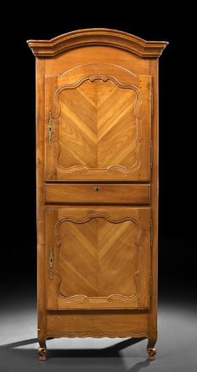 Provincial Louis XV-Style Cherrywood Bonnetiere: Provincial Louis XV-Style Cherrywood Bonnetiere, third quarter 19th century, the domed and molded cornice above a case fitted with a cupboard door over a single drawer and another cupboard, each cupbo