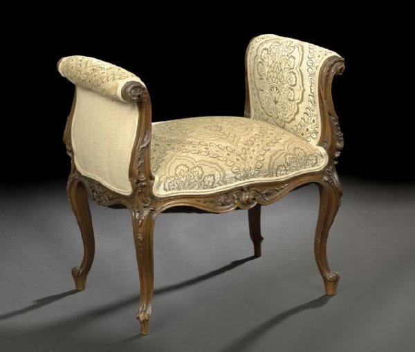 Provincial Louis XV-Style Walnut Window Seat: Provincial Louis XV-Style Walnut Window Seat, third quarter 19th century, the padded seat flanked to either side by a padded outscrolled arm, fronted by foliate carving, above a like-carved shaped apr